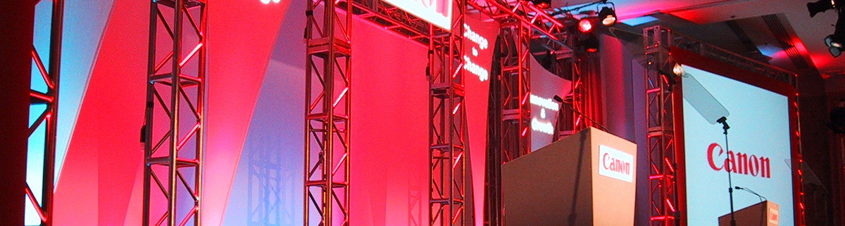 Corporate event stage with red lit truss